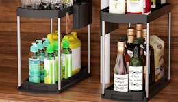 two under-sink organizers with items on them