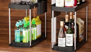 two under-sink organizers with items on them