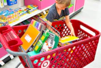 child putting a notebook in a target cart with school supplies