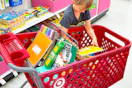 child putting a notebook in a target cart with school supplies