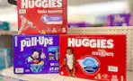 three huggies diaper boxes on a store shelf