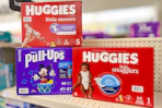 three huggies diaper boxes on a store shelf