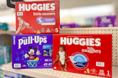 three huggies diaper boxes on a store shelf