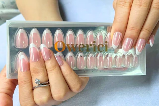 a woman holding french tip nails