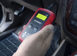 someone using the Kobra™ Professional OBD2 Car Diagnostic Check Engine Code Scanner in their car