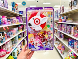 hand holding a target polly pocket doll playset in a toy aisle