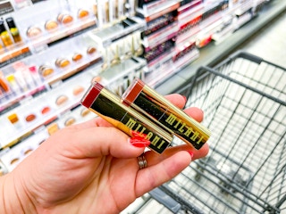 hand holding milani lipsticks in walgreens