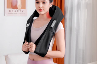 woman wearing a cordless neck massager