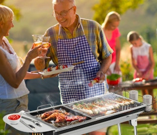 people barbecuing outside