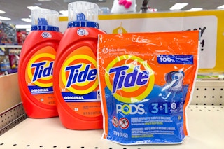 2 large bottles of tide liquid detergent and one pack of tide pods on a shelf