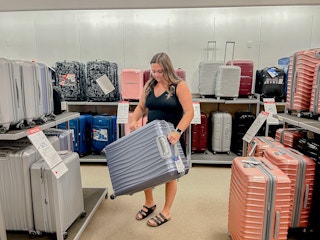 a person looking at luggage at macy's