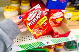 hand holding a pack of hormel pepperoni