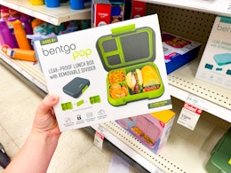 hand holding a bentgo box in front of a target shelf