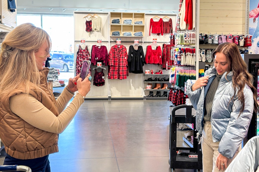 a person taking a photo of another person waering a jacket 