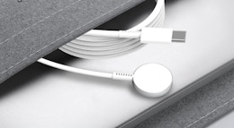 an Apple watch charger in a grey pouch