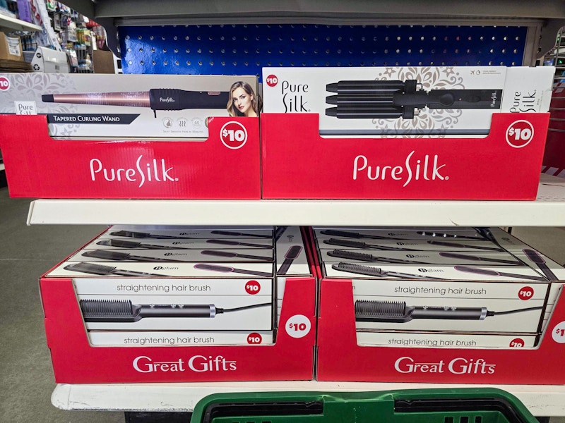 endcap display with straightening hair brushes, curling wands, and curling irons