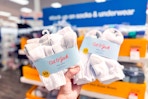 hand holding 2 packs of cat & jack kids' socks at target