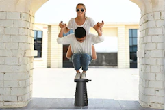 Lifestyle image of the Suproot Telescopic Stool of 2 people balancing on top