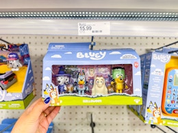 hand grabbing a bluey halloween costume party set off a target shelf