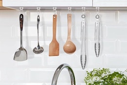 a kitchen utensil hanging on a wall above a sink