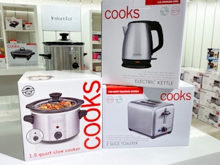 Cooks kitchen appliances on shelf