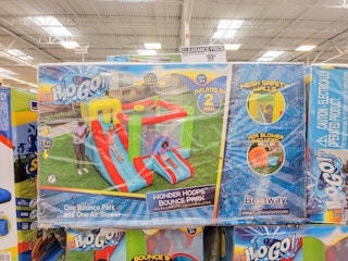 bounce house with slide and basketball hoop