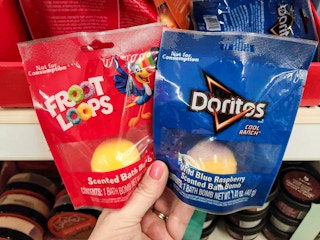 hand holding froot loops & doritos bath bombs
