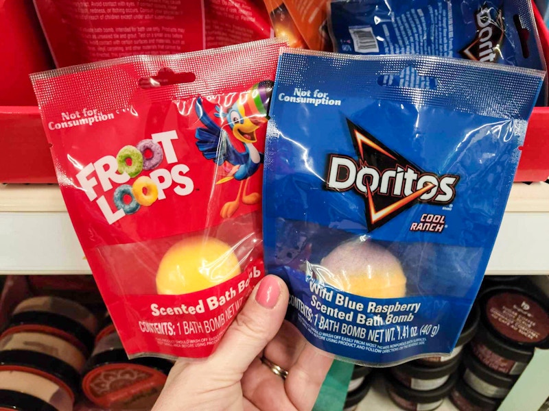 hand holding froot loops & doritos bath bombs