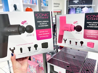 someone holding up a massage gun in both black and pink