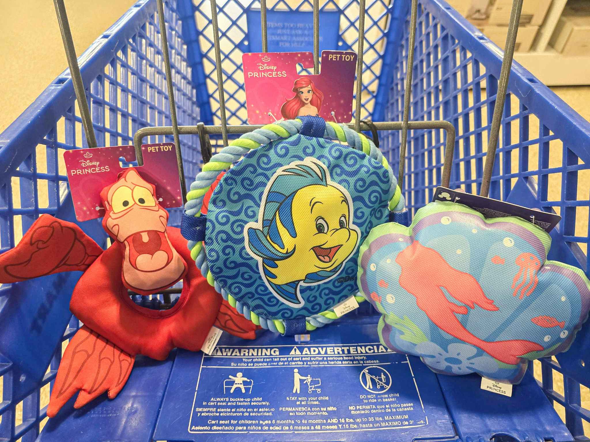 little mermaid themed dog toys in a cart