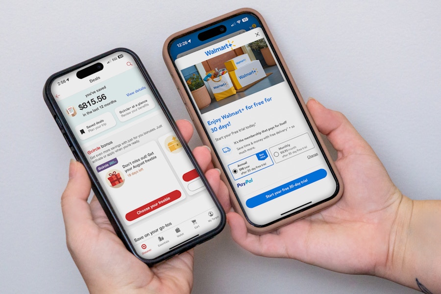 someone holding up two phones, one displaying the Walmart app and the other displaying the Target app