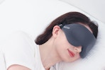 Woman sleeping with the MZOO Luxury Sleep Eye Mask.
