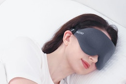 Woman sleeping with the MZOO Luxury Sleep Eye Mask.