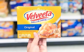 box of velveeta shells & cheese held up
