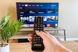 hand pointing remote at tv watching hulu