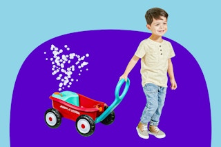 Boy pulling Radio Flyer Wagon behind him (blowing bubbles)