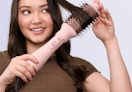 a person using a pink hot sir brush