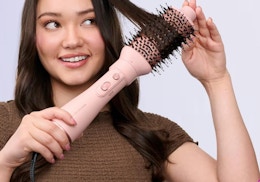 a person using a pink hot sir brush