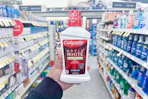 hand holding a bottle of colgate mouthwash