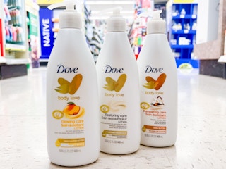 three bottles of dove love body lotion on floor