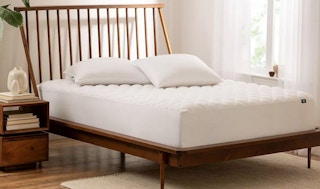 a mattress on a bed with a waterproof mattress pad on it