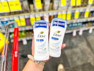 hand holding two deodorants