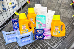 neutrogena makeup wipes, crest toothpaste, skintimate razors, native body wash, and arm & hammer detergent in a cart