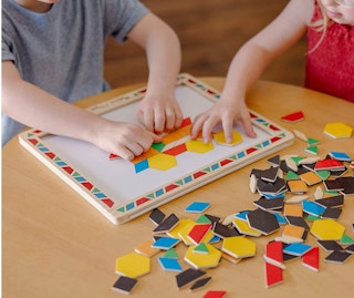 kids playing with a wooden magnetic toy set