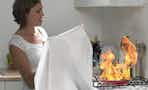 Woman using Emergency Fire Blanket