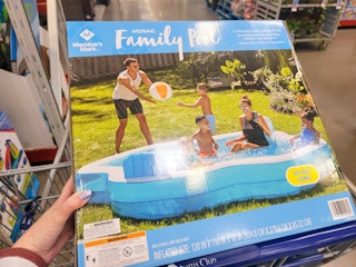 hand holding a family size inflatable pool