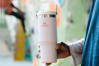 Person holding Stanley Tumbler with top handle