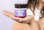 a woman holding magnesium lotion