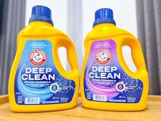 two bottles of Arm & Hammer laundry detergent