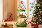 Lifestyle image of the Pinmoco Christmas Tree Metal Storage Rack in a holiday home setting 
